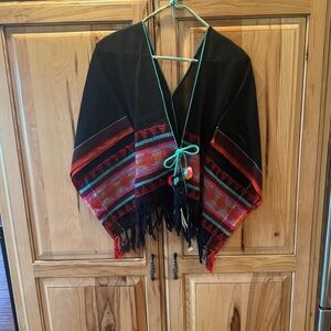 Noonday Collection Black Poncho with Red and Teal Trim